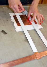 Securing the plate to the hangers with tape