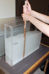 Stirring the salt into the distilled water